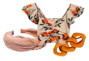 stylish women's summer outfit ensemble featuring a crop top with an orange fruit print, a pink pleated headband, and a chunky orange resin chain necklace.