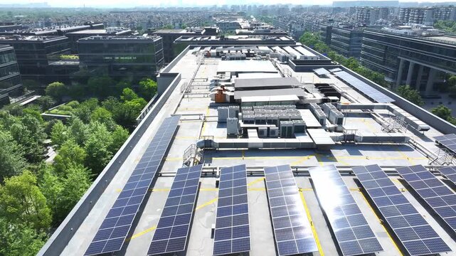 Aerial view of distributed photovoltaic arrays installed on urban industrial park rooftops