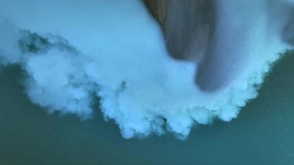 Aerial view of the mesmerizing contrast between deep turquoise water and pristine white snow, creating an abstract landscape, Anchorage, Alaska, United States. - Powered by Adobe