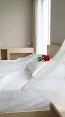 A single red rose on a pillow by the open window