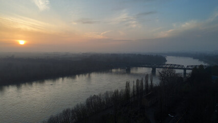 Misty sunrise over the Po River with a bridge in Cremona, Lombardy, Italy