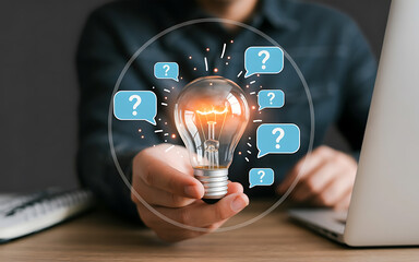 Holding lightbulb with questions
