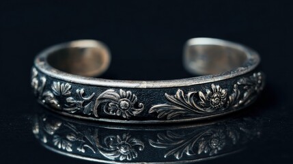 Close-up of an intricate floral detailed silver bracelet.