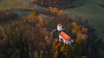 Aerial view of St. Wenceslaus Church in Habrina, Czech Republic, at golden hour.