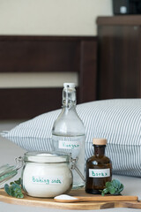Natural eco-friendly pillow cleaning concept using baking soda, vinegar, salt and borax on the background of a striped pillow. Sustainable bedding care concept