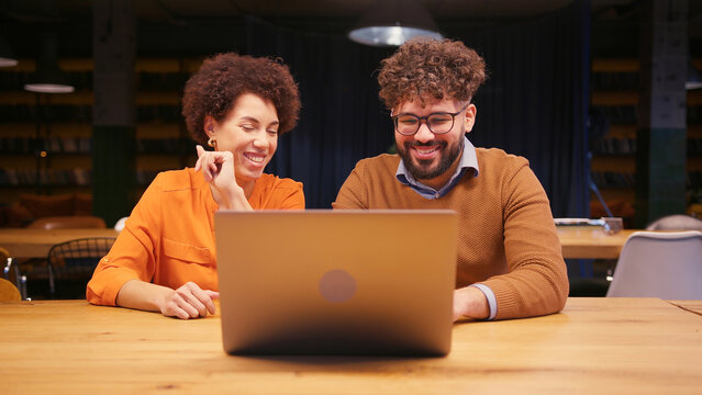 Successful professionals businessman and businesswoman having win using laptop - Powered by Adobe