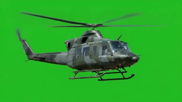 Military helicopter in flight with camouflage pattern against green screen background, Army aircraft hovering with rotor blades spinning
