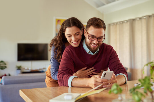 Mid adult couple enjoying social media at home