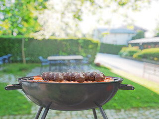 summer time in backyard garden with grill BBQ, blurred background