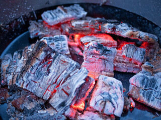 barbecue BBQ grill with flaming fire and ember charcoal on black background