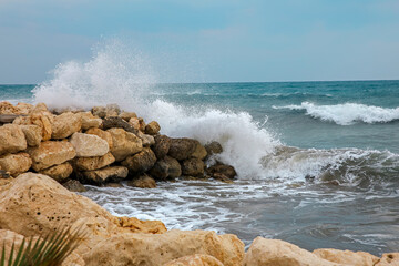 waves crashing on rocks near the sea	