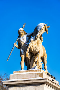 Arab Warrior statue stands at Pont d'Iena in Paris, installed in 1853. Winter scene features the snow-covered stone warrior and horse against a blue sky
