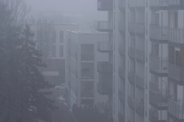 Toxic smog over residential buildings in the city during winter.