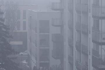 Toxic smog over residential buildings in the city during winter.