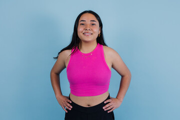 portrait of young latin teenager girl with copy space on blue background in Mexico Latin America, Hispanic woman