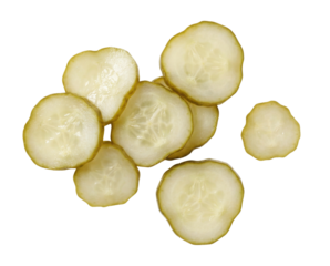 A small pile of thinly sliced green pickles, showing the interior seeds and flesh. The pickle rounds are varied in size.