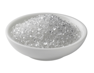 A white ceramic bowl filled with a mound of tiny, clear, faceted crystalline fragments.
