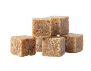 A small, rough-textured stack of unrefined brown sugar cubes, showcasing their crystalline structure and warm, caramel color.