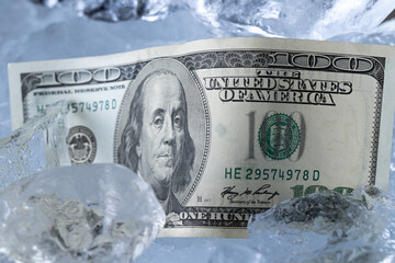 One Hundred Dollar Banknote Between Ice Blocks