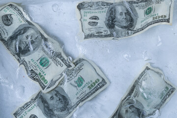Multiple One Hundred Dollar Bills in Ice