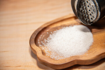 Salt on a plate, poured out of a salt shaker