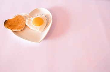Valentines   heart  shapped egg and  roast  on a  heart shaped  plate  romantic  love breakfast 