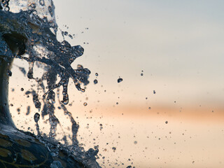 The fountain from the earthenware pot reflects the evening light.