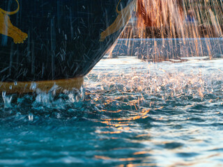 The fountain from the earthenware pot reflects the evening light.