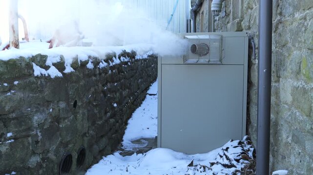 4K: Outside Oil Boiler in Winter emitting Plumes of Steam. Votex boiler exterior in Snow and ice cold Weather. Stock Video Clip Footage.