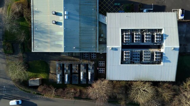 Aerial view of the Six Degrees data centre, showcasing rooftops with industrial equipment amid winter trees, Redditch, United Kingdom.