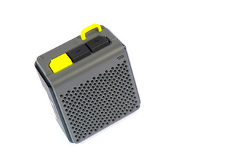 Wireless music speaker isolated on white. A modern grey audio gadget with yellow details, perfect for technology and entertainment concepts.