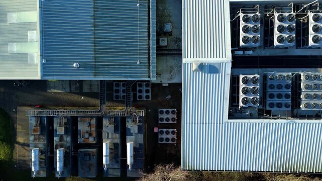 Aerial view of the Six Degrees data centre's rooftop array, a symphony of silver and blue contrasting with the network of cooling systems, Redditch, United Kingdom.