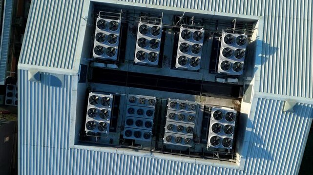 Aerial view of the Six Degrees data centre with its metallic roof and multiple cooling units in orderly rows, Redditch, United Kingdom.
