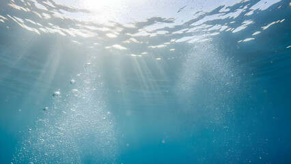 Underwater scene with sunbeams shining through the water and bubbles rising towards the surface