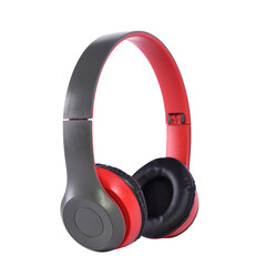 Wireless headphones, grey, red and black, side view on isolated background