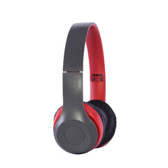 Wireless headphones, grey, red and black, side view on isolated background