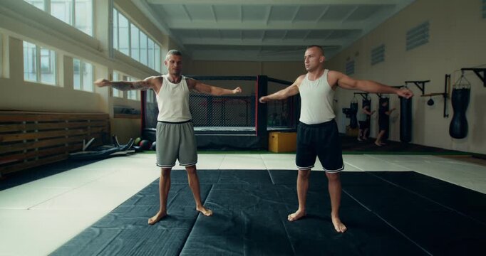 MMA fighters do hand warm-up exercises before training.