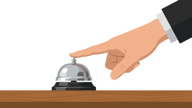 Hand pressing a silver desk bell on a wooden surface, indicating a request for service or attention, commonly found in hotels or reception areas.