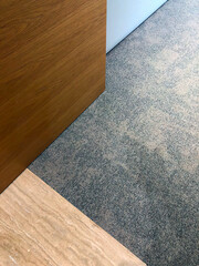 An abstract dialogue of surfaces, where natural grain, soft textile, and stone converge in quiet architectural balance.