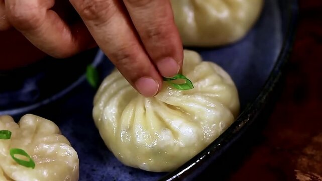 Soft steamed dumpling prepared with delicate folds and juicy filling. These momos are served hot and fresh, making the dish ideal for Asian cuisine menus and food presentation visuals.