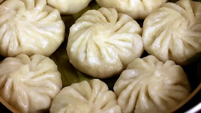 Soft steamed dumpling prepared with delicate folds and juicy filling. These momos are served hot and fresh, making the dish ideal for Asian cuisine menus and food presentation visuals.