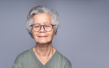 Calm elderly woman portrait showing mindfulness and inner peace.