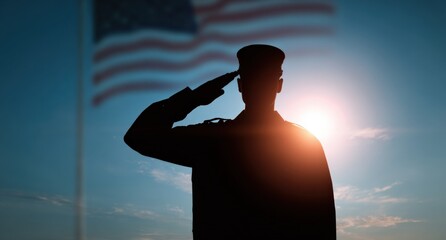 Silhouette of male soldier saluting american flag at sunset
