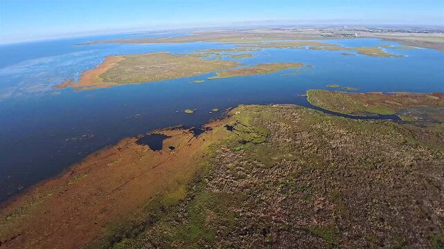 Aerial view of the dark blue waters of Lake Okeechobee meeting the wild grasses along the shoreline, Lake Okeechobee, Florida, United States.