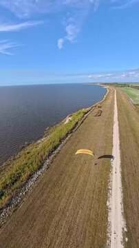 Aerial view of the golden landscape meeting the dark waters of Lake Okeechobee under a clear blue sky, Lake Okeechobee, Florida, United States.