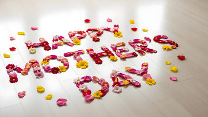A colorful floral arrangement spelling out Happy Mother's Day on a floor