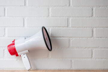 megaphone or speaker isolated on a white wall with copy space
