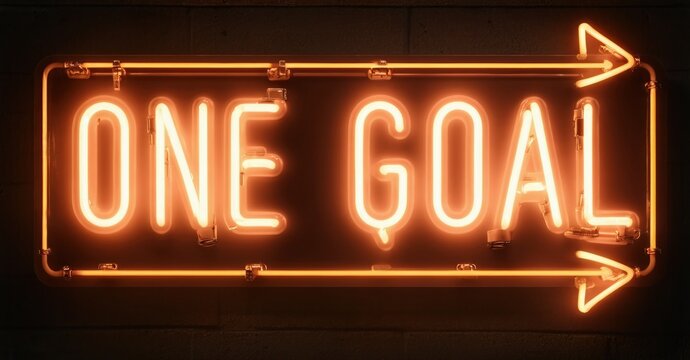 Bright neon sign displays one goal with arrow pointing right. Dark background emphasizes glowing orange illumination. Simple, motivational message. - Powered by Adobe