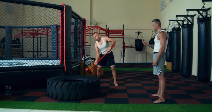 A male MMA fighter performs exercises to develop endurance. .
