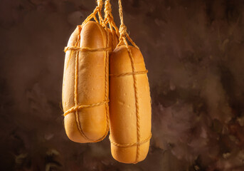 Provolone cheese, wonderful smoked provolone cheese, abstract background, selective focus.